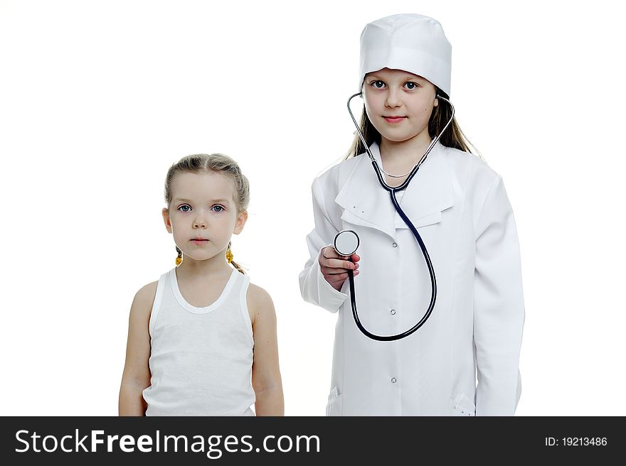 An image of two little girls playing doctors. An image of two little girls playing doctors