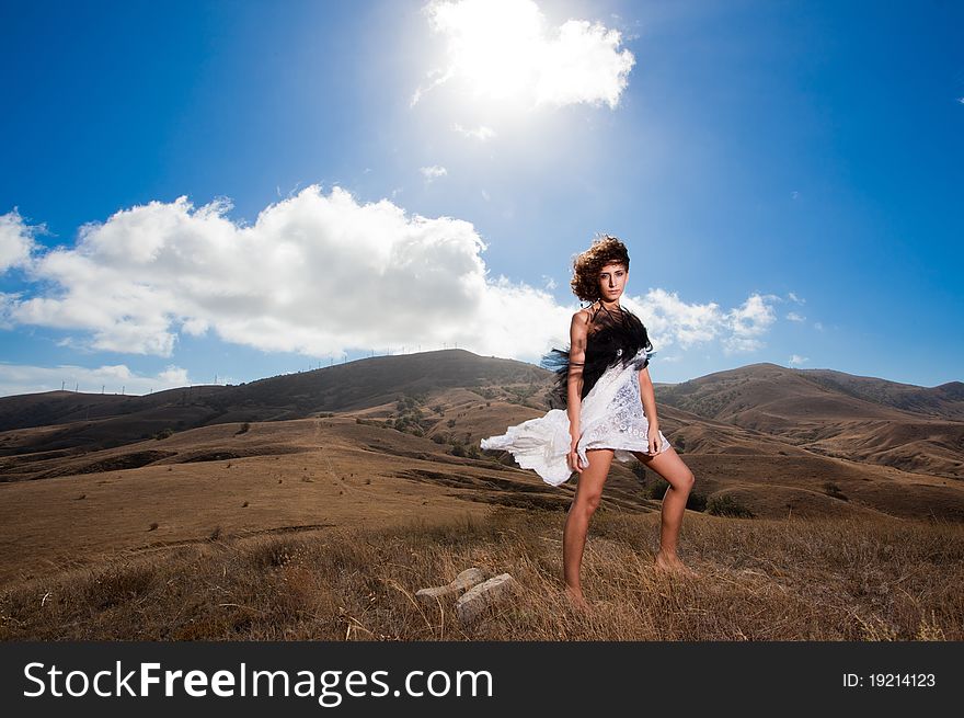 Beautiful Curly Woman Pose In The Mountains