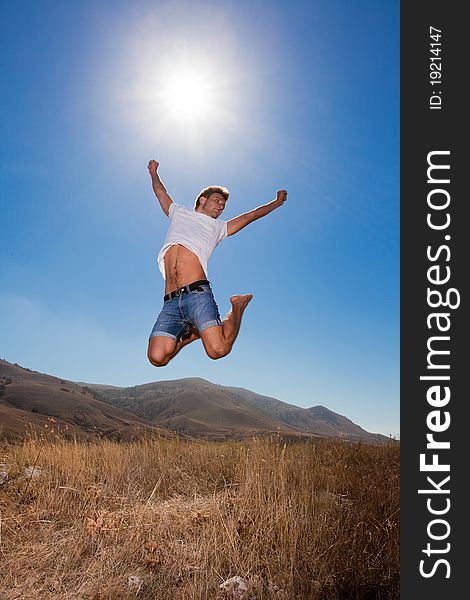 Happy young man jump in the summer mountains. Happy young man jump in the summer mountains