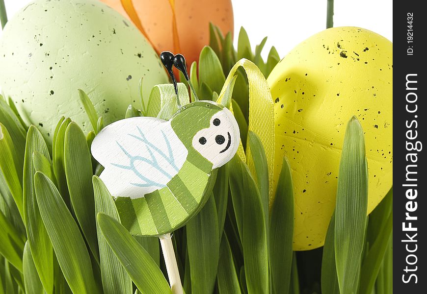 Colorful traditional Easter decoration with grass and artificial eggs