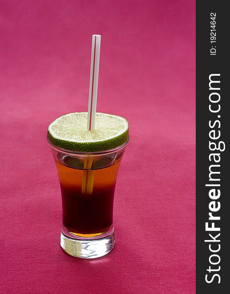 Alcohol cocktail on red background