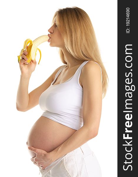 Pregnant woman is sexually bites banana isolated on white