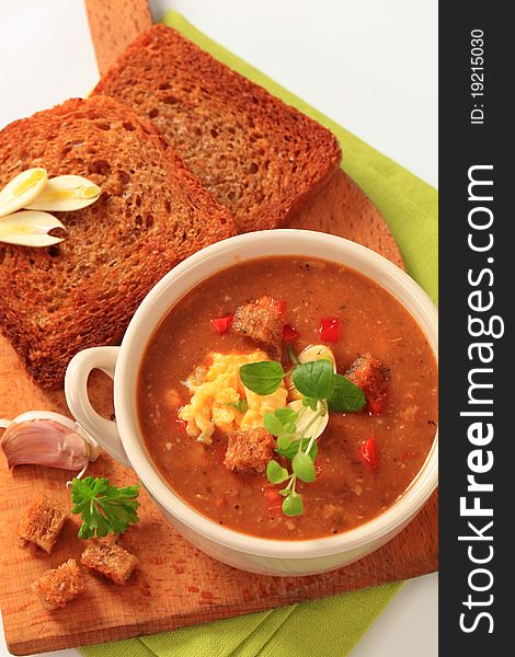 Cup of vegetarian goulash soup and fried bread