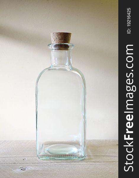 Old glass bottle on wooden shelf