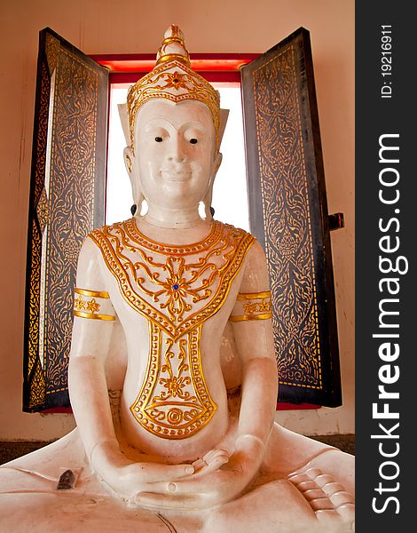 White buddhist monk statue with window light at the back. White buddhist monk statue with window light at the back
