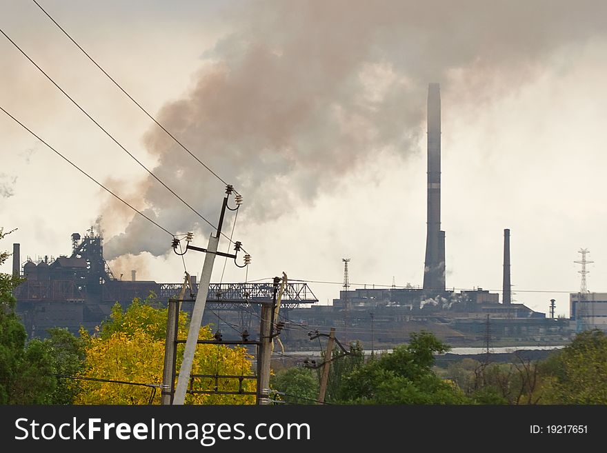 Large metallurgical factory destroying the nature with smoke and waste. Large metallurgical factory destroying the nature with smoke and waste