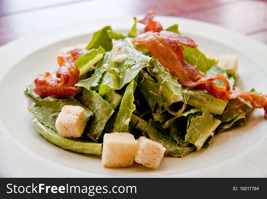 Bacon salad in the white plate