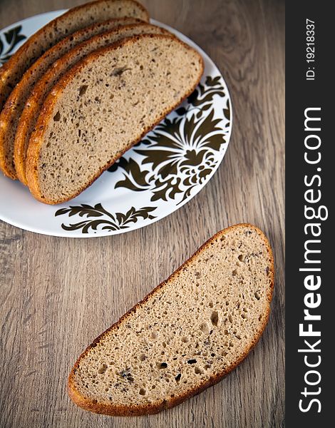 Close-up cut grey bread with cumin on a plate