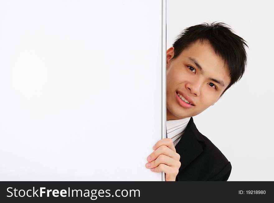 An Asian businessman holding a blank whiteboard. An Asian businessman holding a blank whiteboard