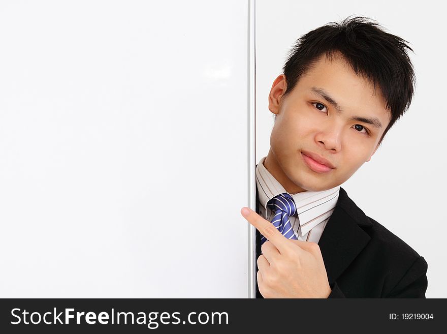 An Asian businessman pointing at a blank whiteboard. An Asian businessman pointing at a blank whiteboard