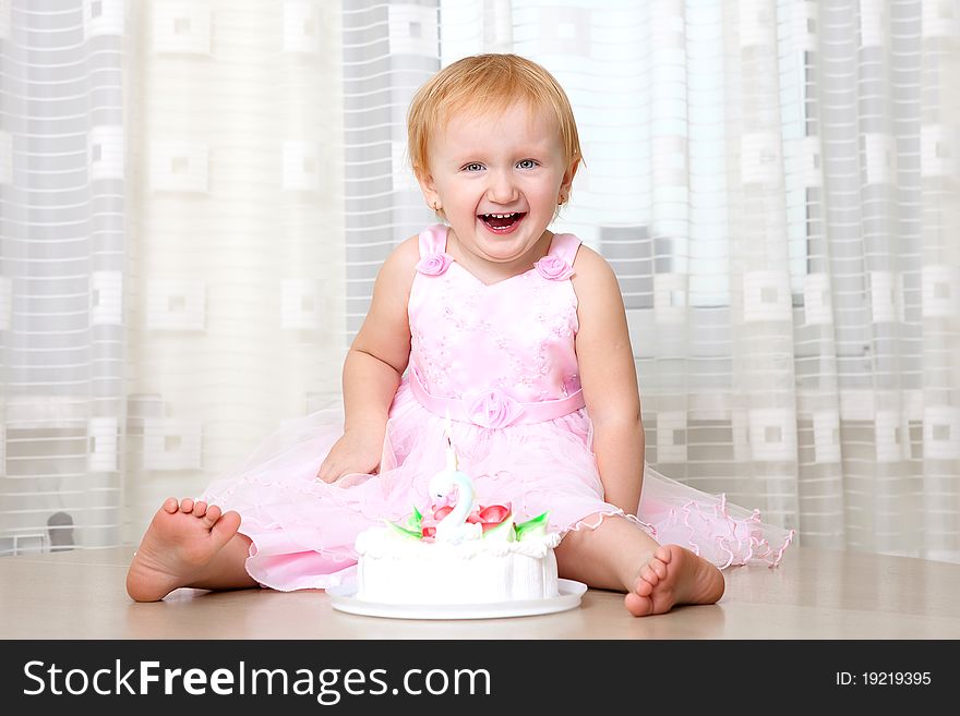 Girl enjoying her first birthday cake. Girl enjoying her first birthday cake