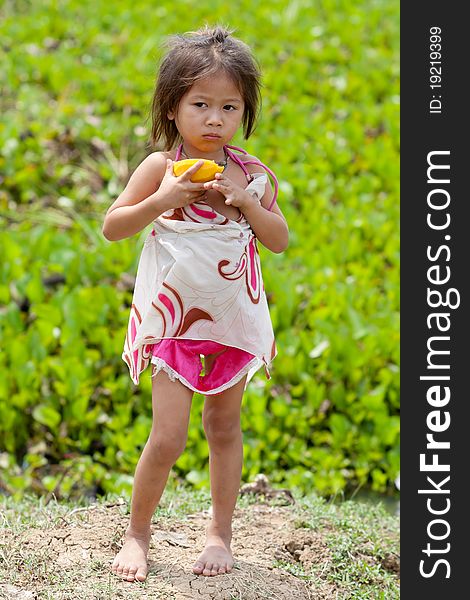 Portrait of asian girl, cute child eat a mango