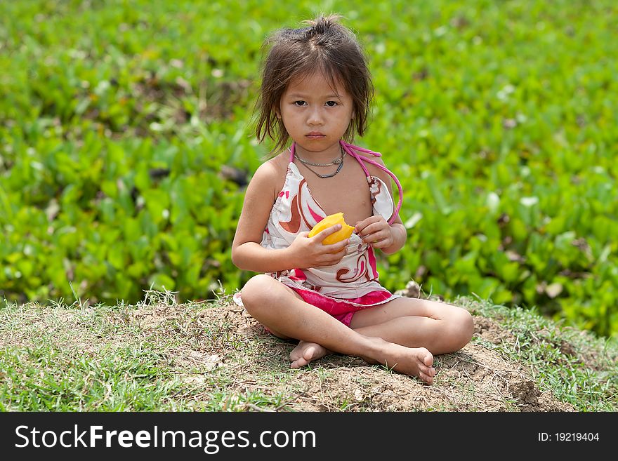 Portrait of asian girl, cute child eat a mango