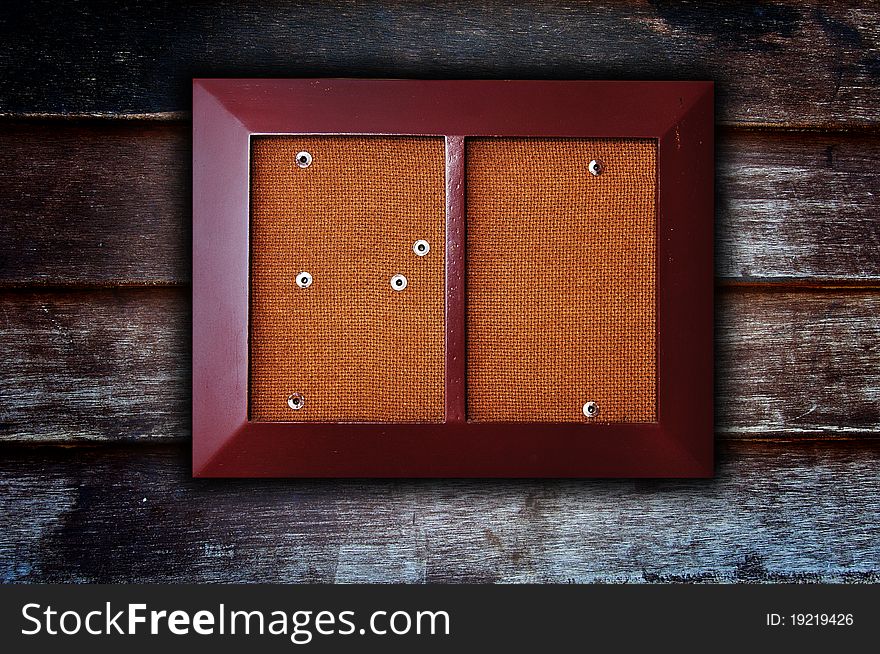 The isolated photo frame decorates on old wooden background. The isolated photo frame decorates on old wooden background