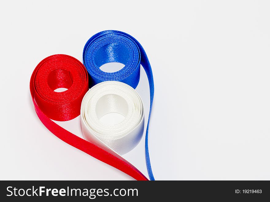 Red white and blue ribbon in shape of a heart. Red white and blue ribbon in shape of a heart
