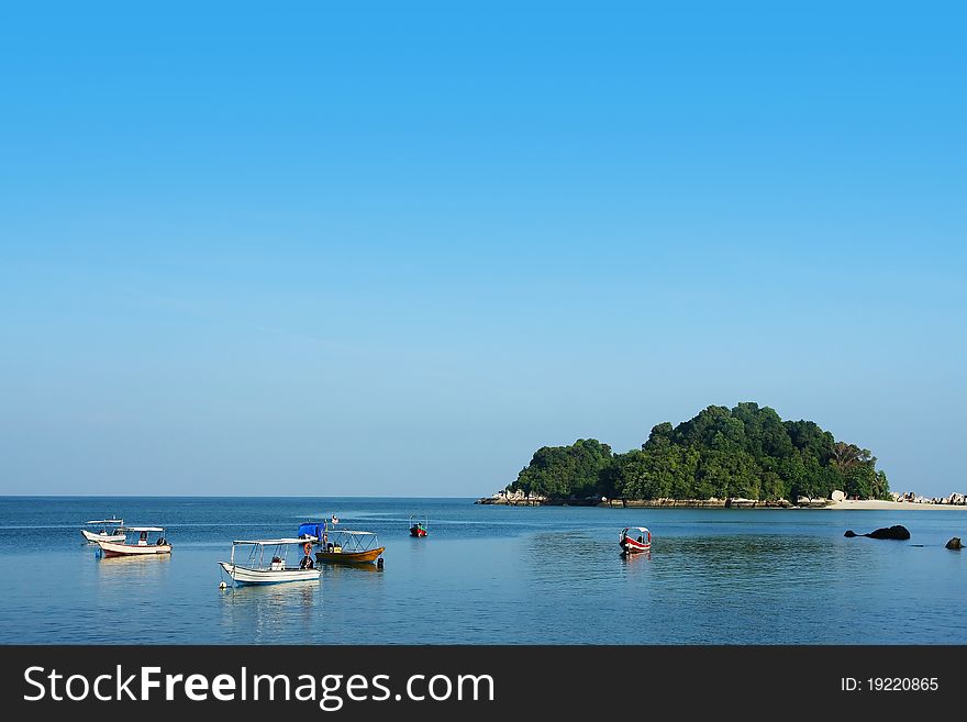 Small island and boat with blue sky