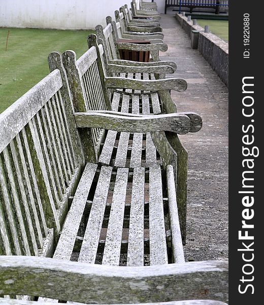 A row of benches near a bowling green in Tenby