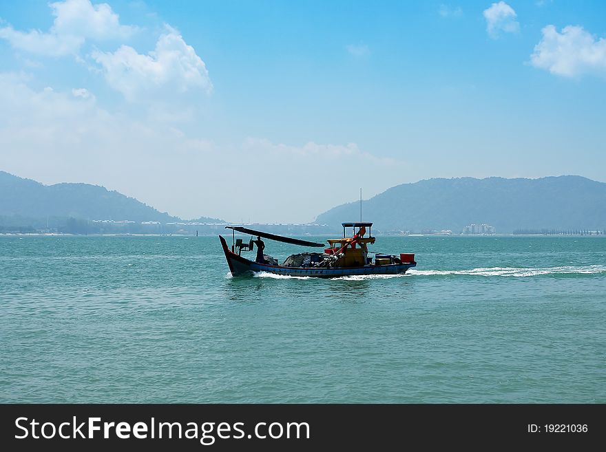 Small fishing boat on summer light