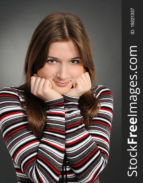 Portrait of the attractive woman on a grey background. Portrait of the attractive woman on a grey background