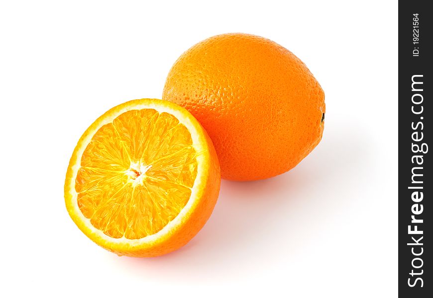 Whole and half cut oranges isolated on white background