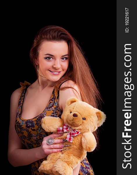 Beautiful longhair girl is holding the teddy bear. Beautiful longhair girl is holding the teddy bear