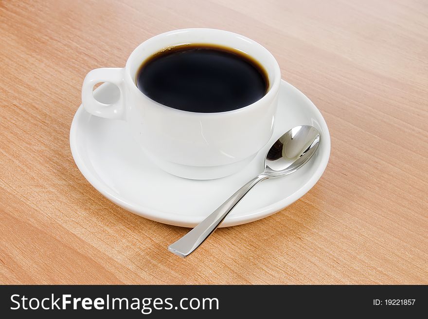 Cup of black coffee on wooden table. Cup of black coffee on wooden table