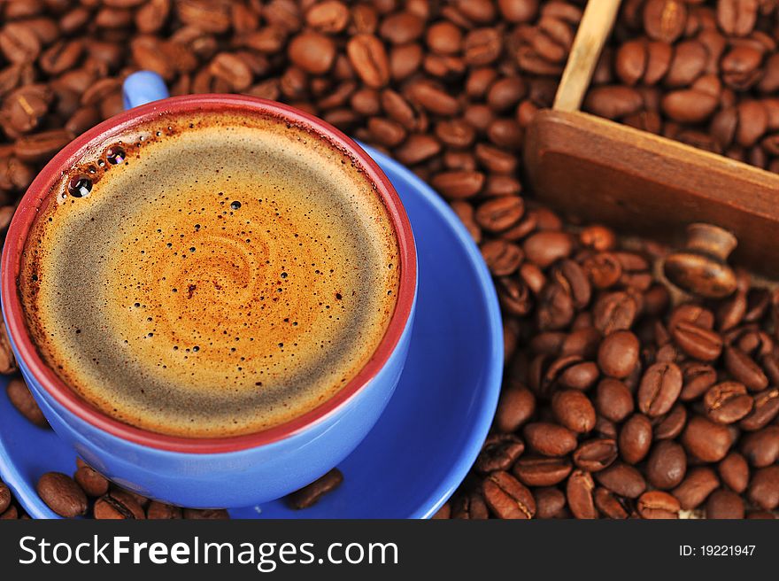 Cup of  coffee and spilled out coffee beans