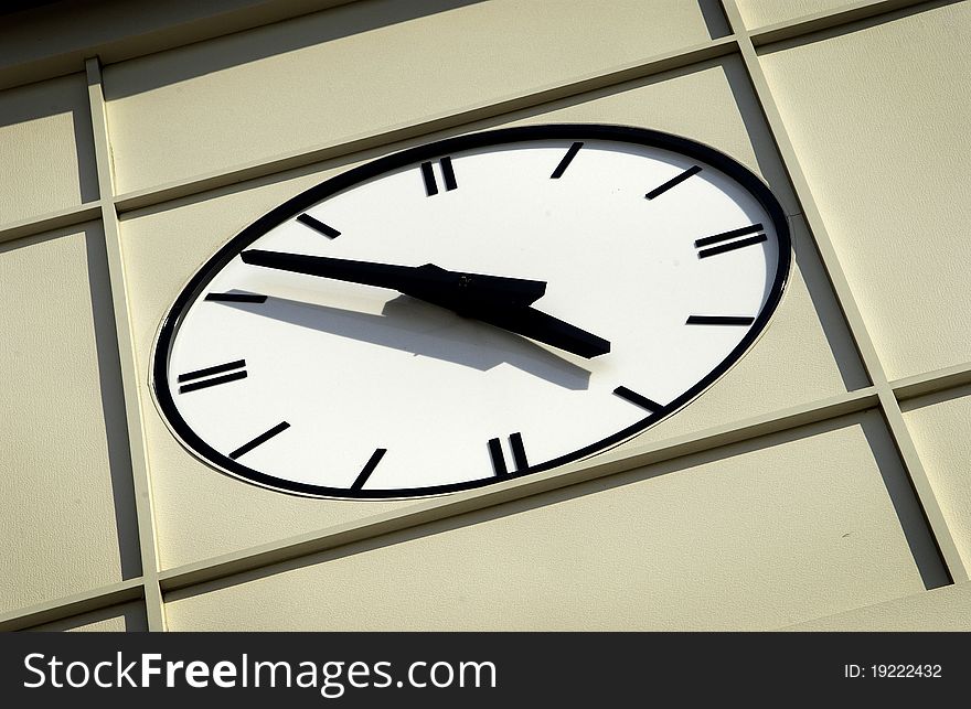 Close up of face of modern clock on side of building. Close up of face of modern clock on side of building