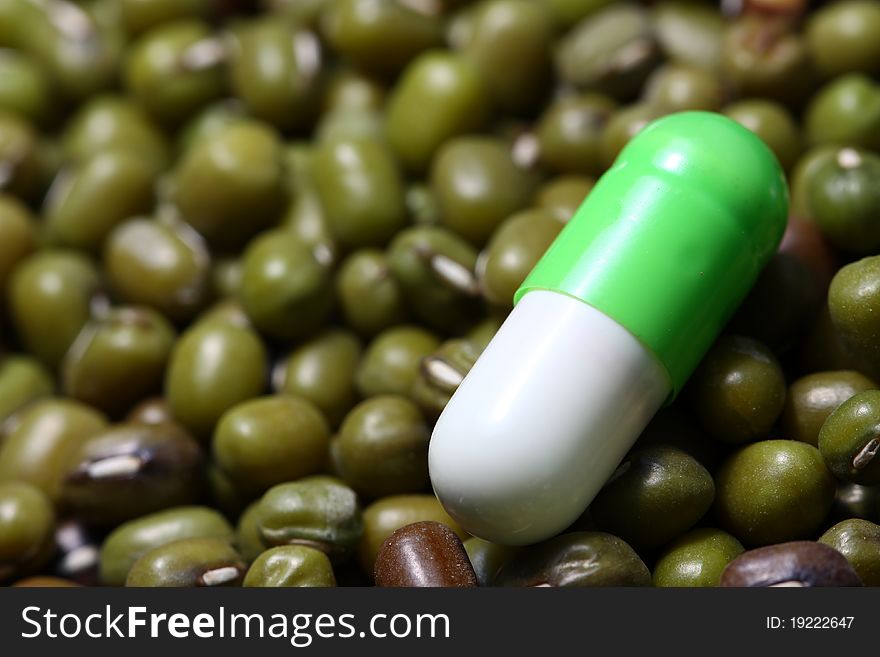 Natural vitamin pill on green beans. Natural vitamin pill on green beans.