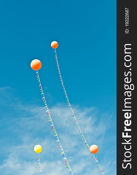 Balloons with Streamers in a Blue Sky