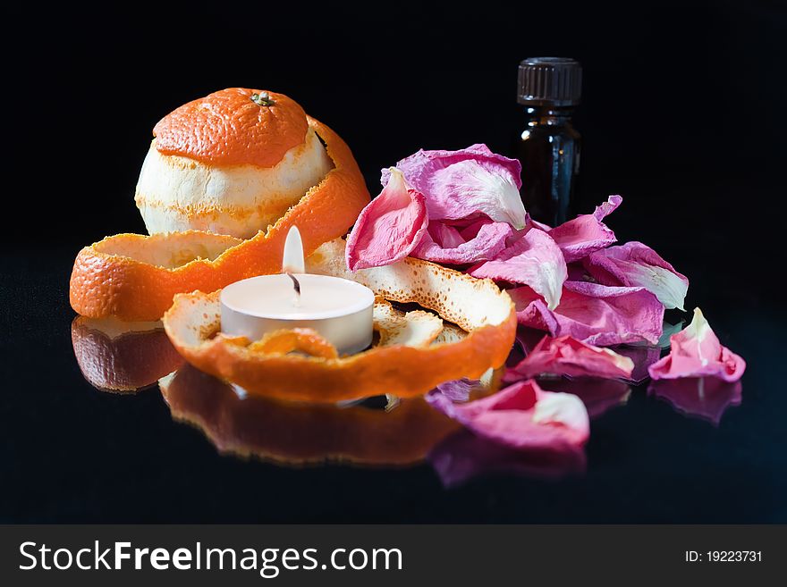 Bottle of aromatic essence, orange,Ñandle, rose-petals. Bottle of aromatic essence, orange,Ñandle, rose-petals.