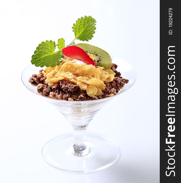 Chocolate granola and corn flakes topped with fruit. Chocolate granola and corn flakes topped with fruit