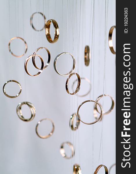 Several gold rings on a light background