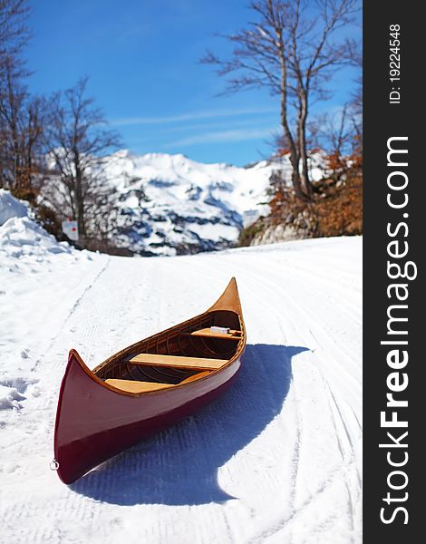 Wooden canoe on the snow ski slope