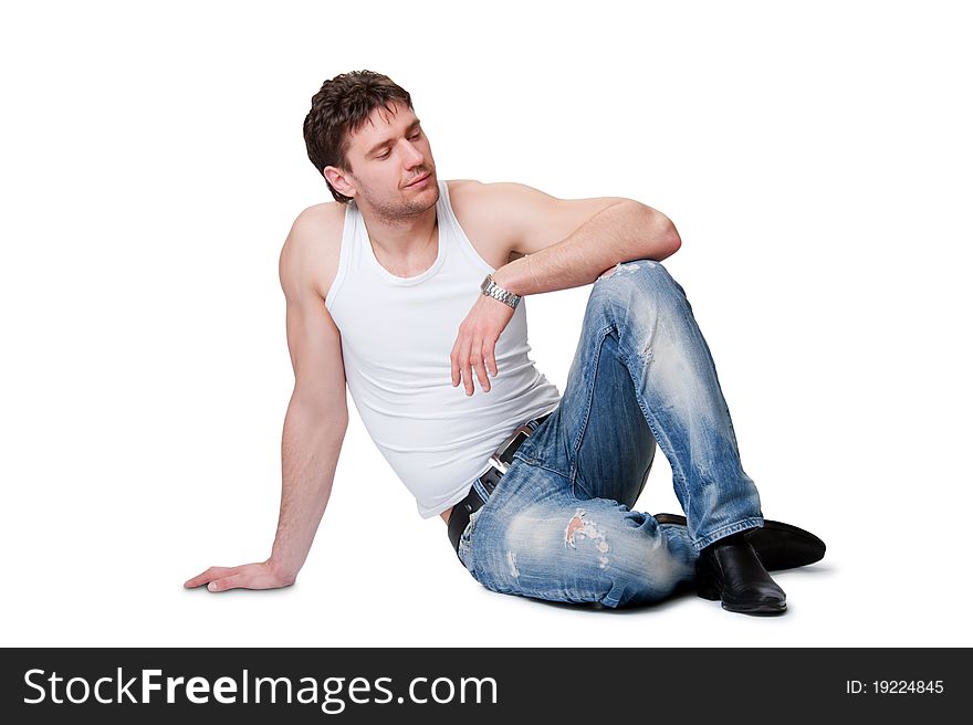 Man in jeans sitting on an isolated background
