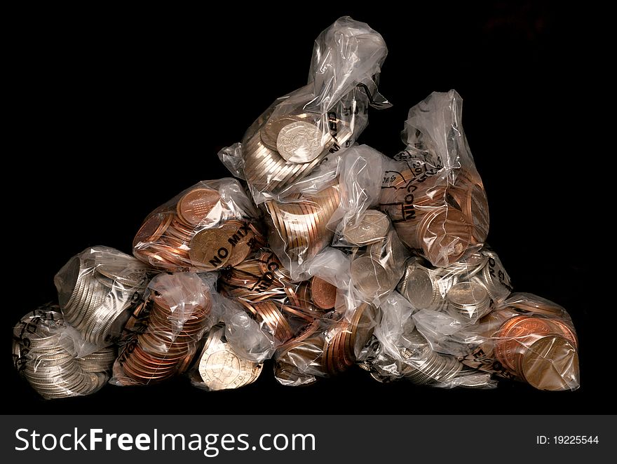 Pile of sterling coins in money bags studio cutout