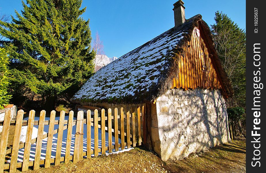 Typical country house with a thathed roof in chartreuse park in french alps in winter