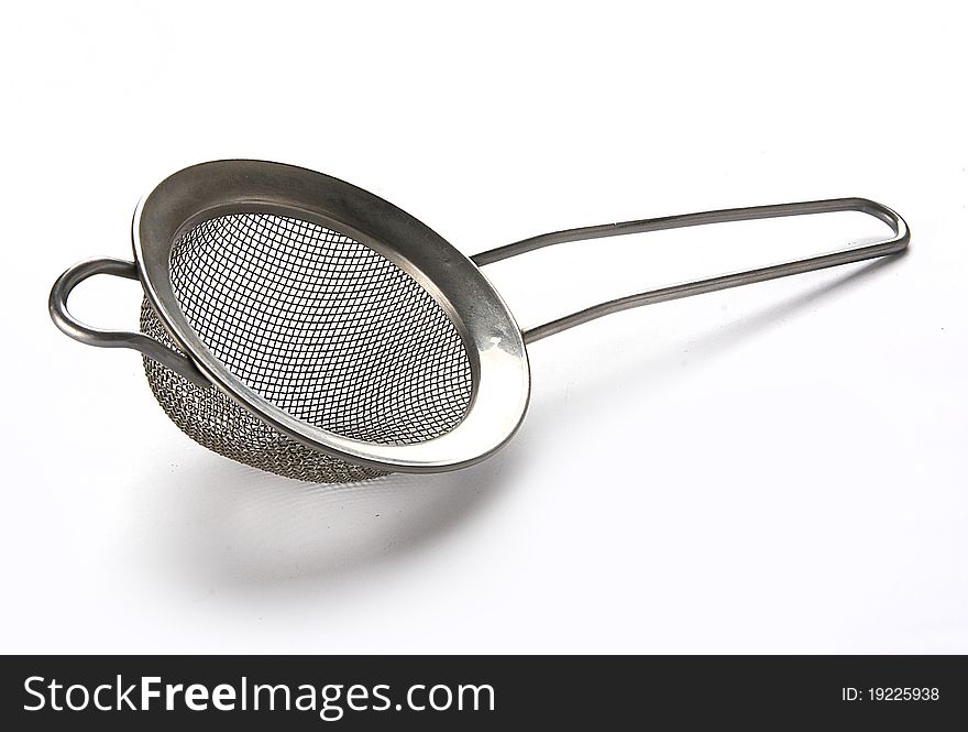 Metal tea strainer on the white background