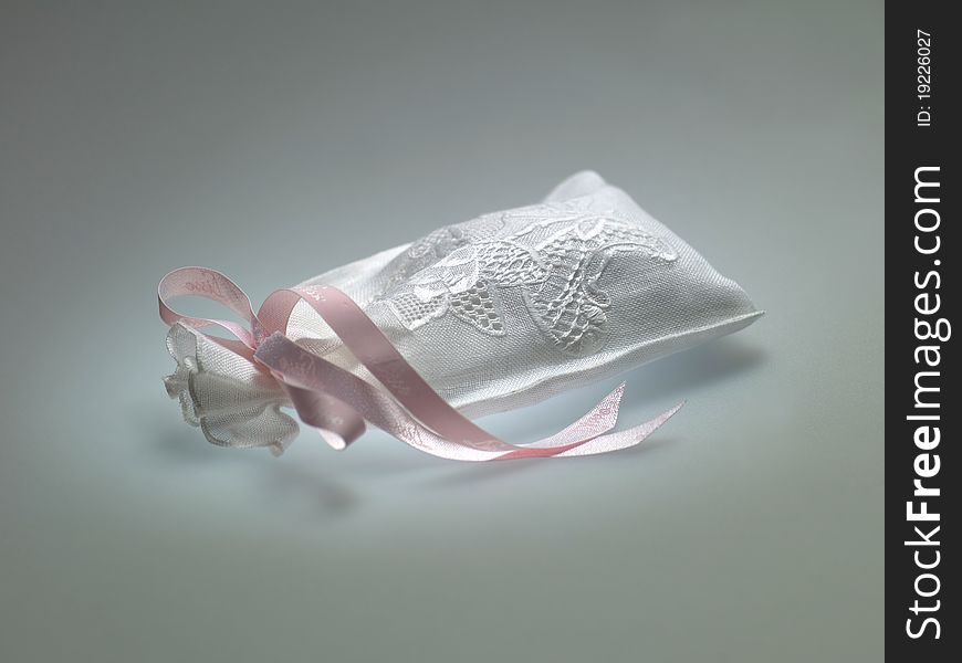 A small bag with a pink ribbon