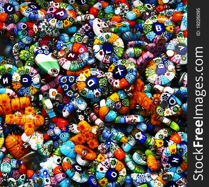 Glass and plastic bright colorful costume jewellery on a street market table. Good for background. Glass and plastic bright colorful costume jewellery on a street market table. Good for background.