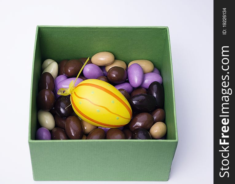 Chocolate almonds with diferent colors in a green box