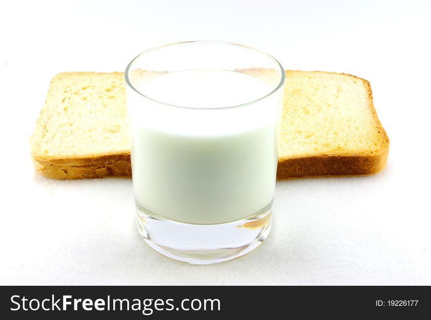 Toasted bread and a glass of milk isolated in white background. Toasted bread and a glass of milk isolated in white background