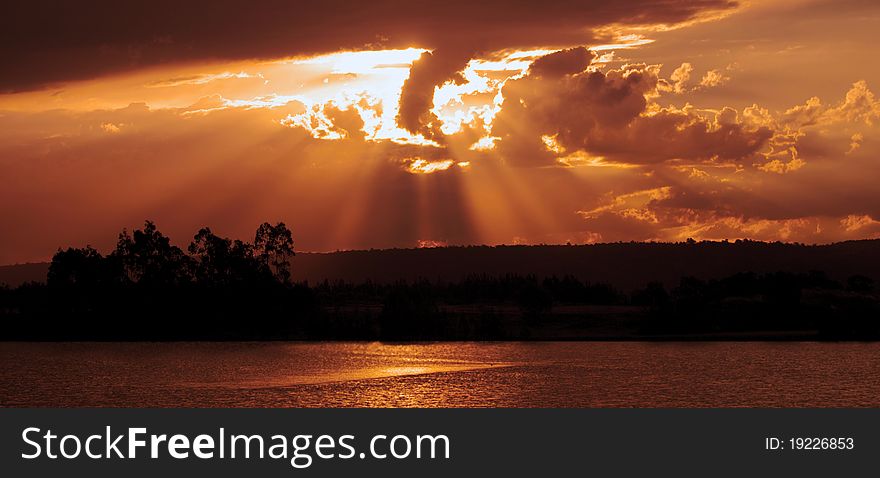 A river at sunset. Silhouette on red yellow and orange. A river at sunset. Silhouette on red yellow and orange.