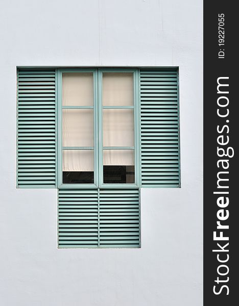 Window in light green color with wooden grid and simple white cloth curtain. Window in light green color with wooden grid and simple white cloth curtain.