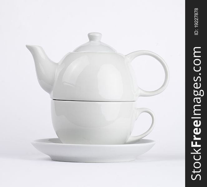 White cup of tea with teapot. White cup of tea with teapot