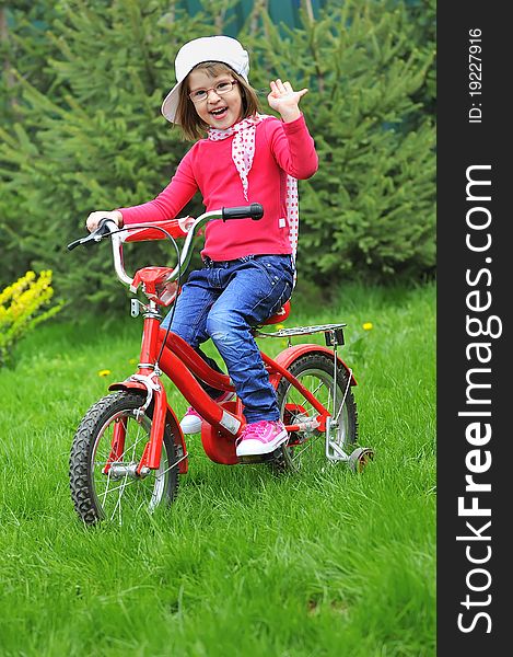 Little girl with bike in garden