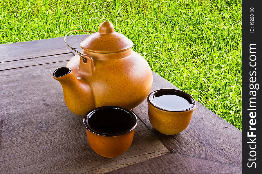 Earthenware tea pot with two cups