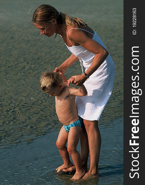 Young woman with her son walking on water. Young woman with her son walking on water