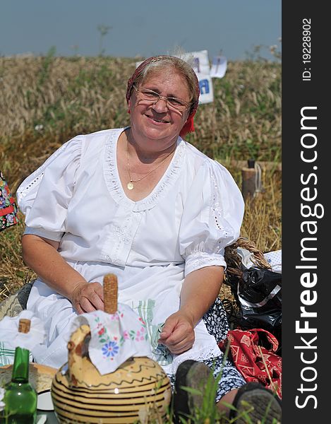 Traditional breakfast in a field at the time of harvest. Hungarian folk costume. Traditional breakfast in a field at the time of harvest. Hungarian folk costume