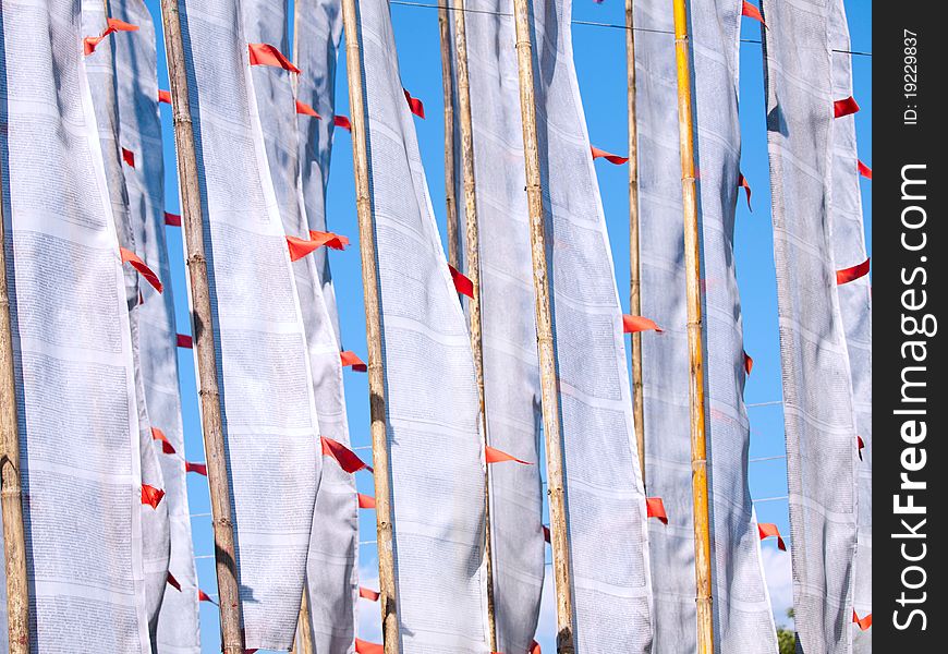 White large prayer flags over a clear blue sky